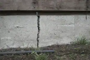 Concrete wall crack on a Long Island home showing visible structural damage, highlighting the need for local repair and waterproofing services.